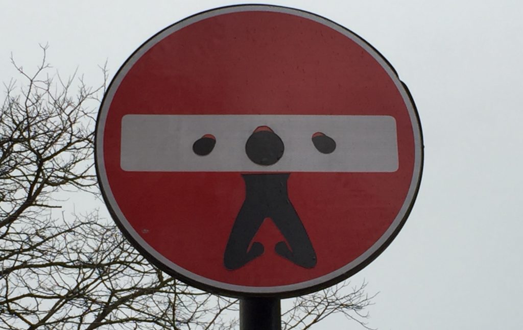 road sign with graffiti dran to put man in gallows