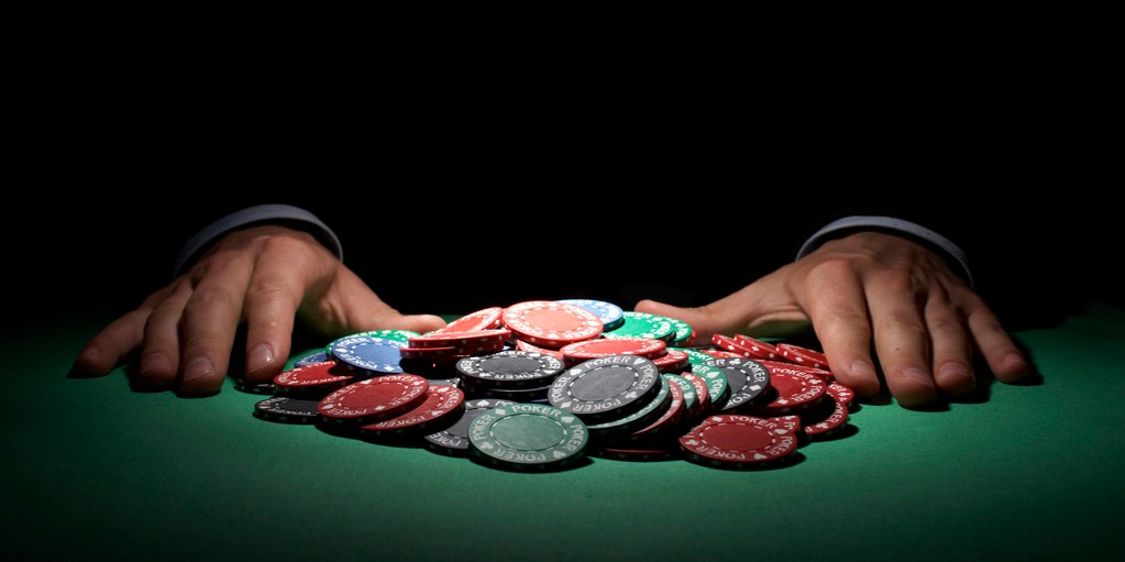 pile of poker chips being pushed in