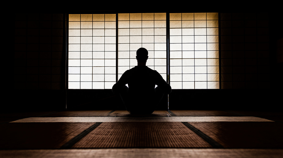 person meditating in zen room
