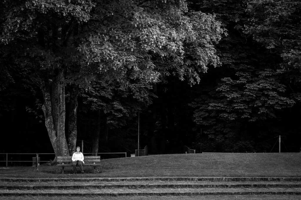 person lingering on a park bench