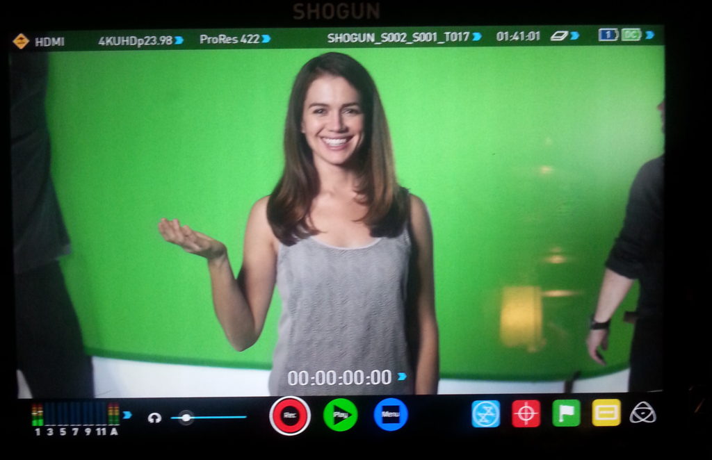 woman smiling infront of green screen