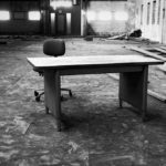 desolate looking empty desk in empty building