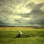 person sitting loner in a field