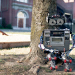 robot sitting in front of a tree