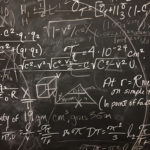 messy chalkboard with formulas