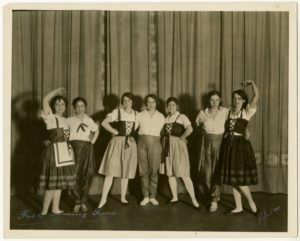 comedy women standing grouped on a stage